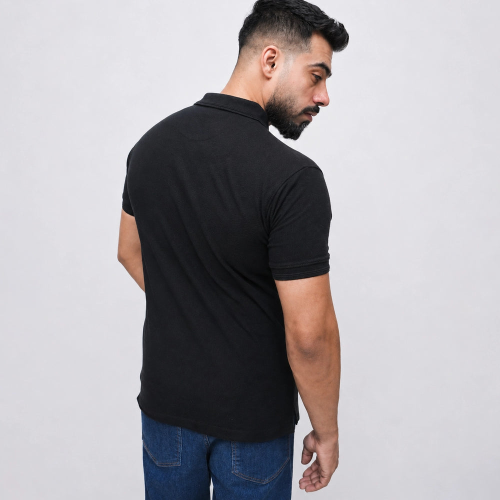 Black polo shirt back view showing relaxed fit and clean stitching detail 2