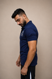 Man wearing navy polo shirt, side profile, regular fit