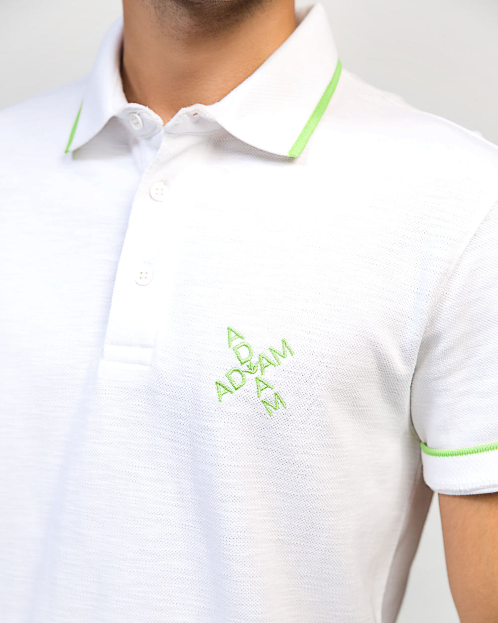 ADAM White Regular Fit Polo – Close-Up of Embroidered Chest Logo and Contrast Tipping Detail