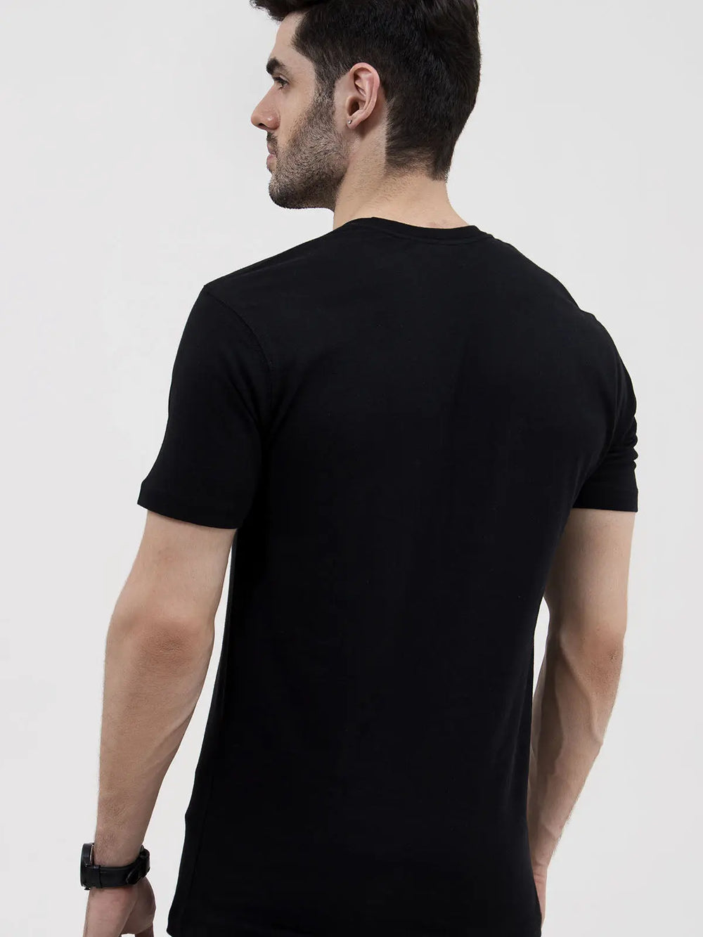 Man in black round neck t-shirt back view, studio shot, white background