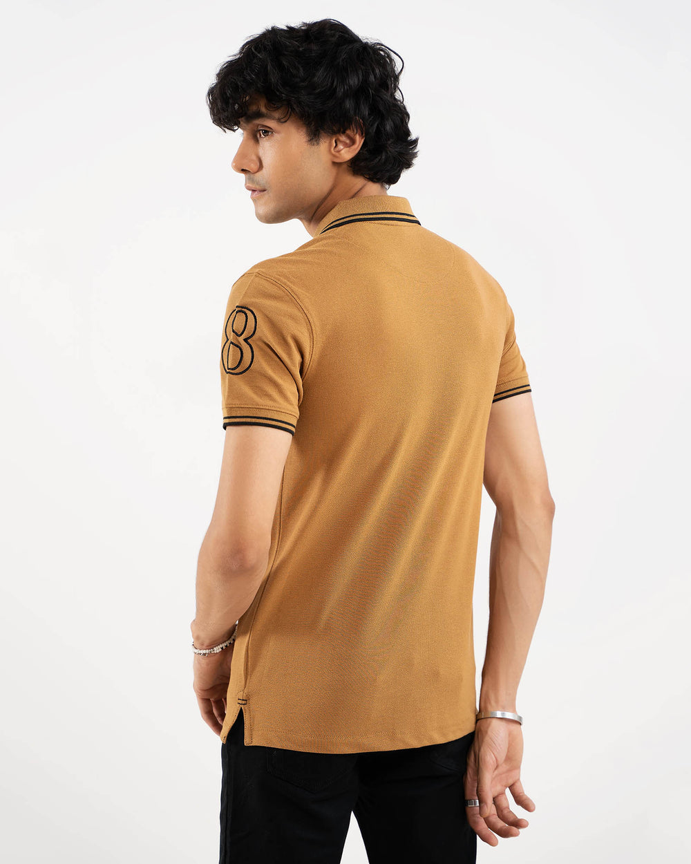 Camel tan polo shirt, black tipping collar, back view