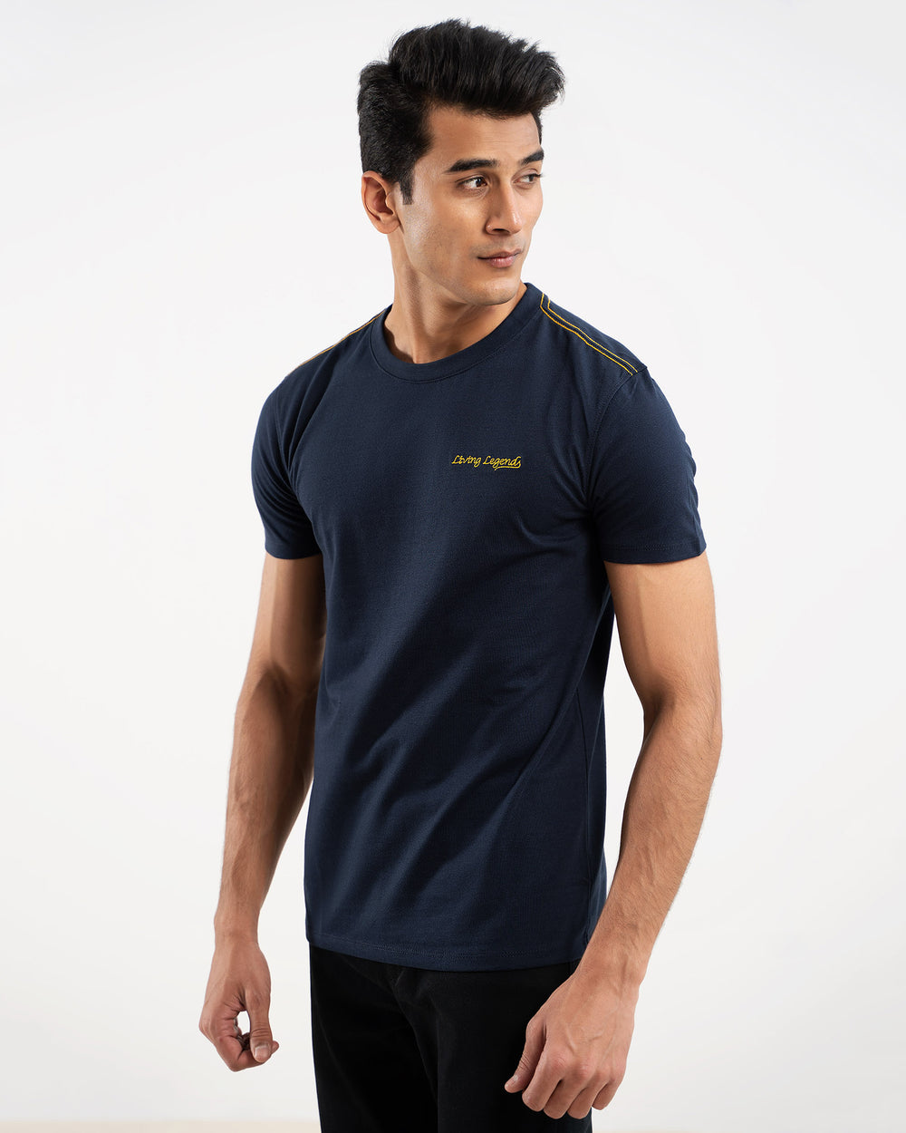 Man in navy blue t-shirt with shoulder stripe, side view