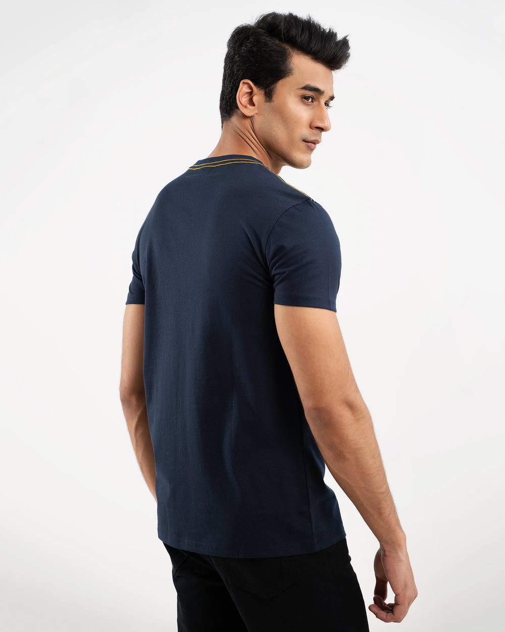Man in navy blue t-shirt with shoulder stripe detail, back view