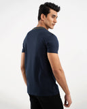Man in navy blue t-shirt with shoulder stripe detail, back view