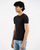 Man in black t-shirt with red script print, side view