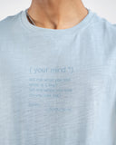 Close-up of light blue t-shirt with small printed quote text on chest