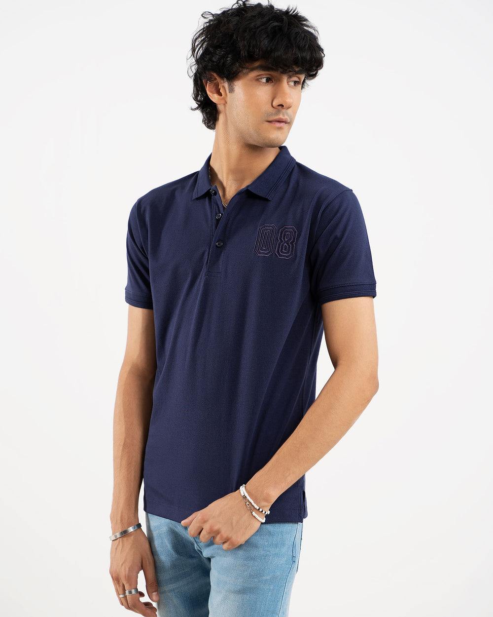 Man in navy blue polo shirt, side view