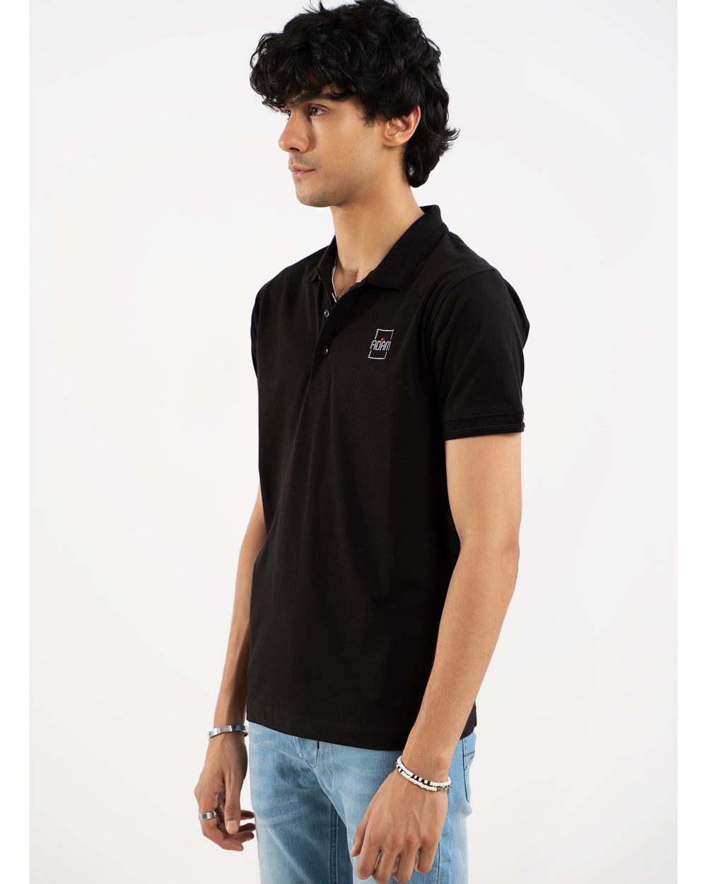 Man in black polo shirt, side view