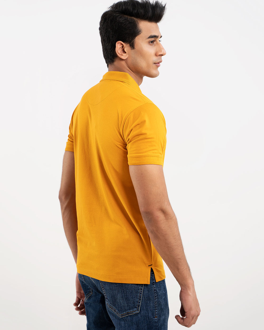 Man in mustard yellow polo shirt, back view