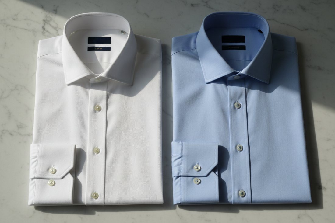 Men's formal shirts in white and light blue laid flat showing fabric texture and collar detail, Pakistan office wear
