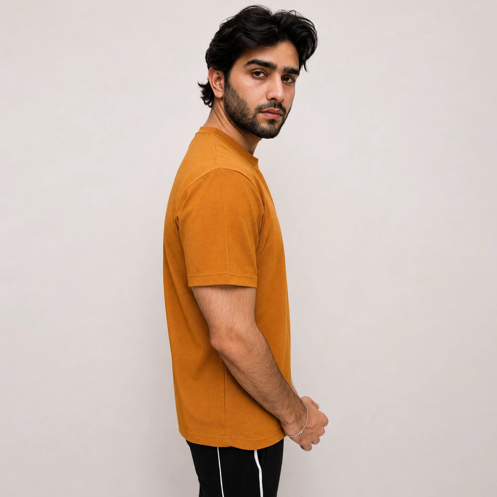 Side profile of relaxed fit mesh tee highlighting loose, breathable silhouette