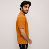 Side profile of relaxed fit mesh tee highlighting loose, breathable silhouette