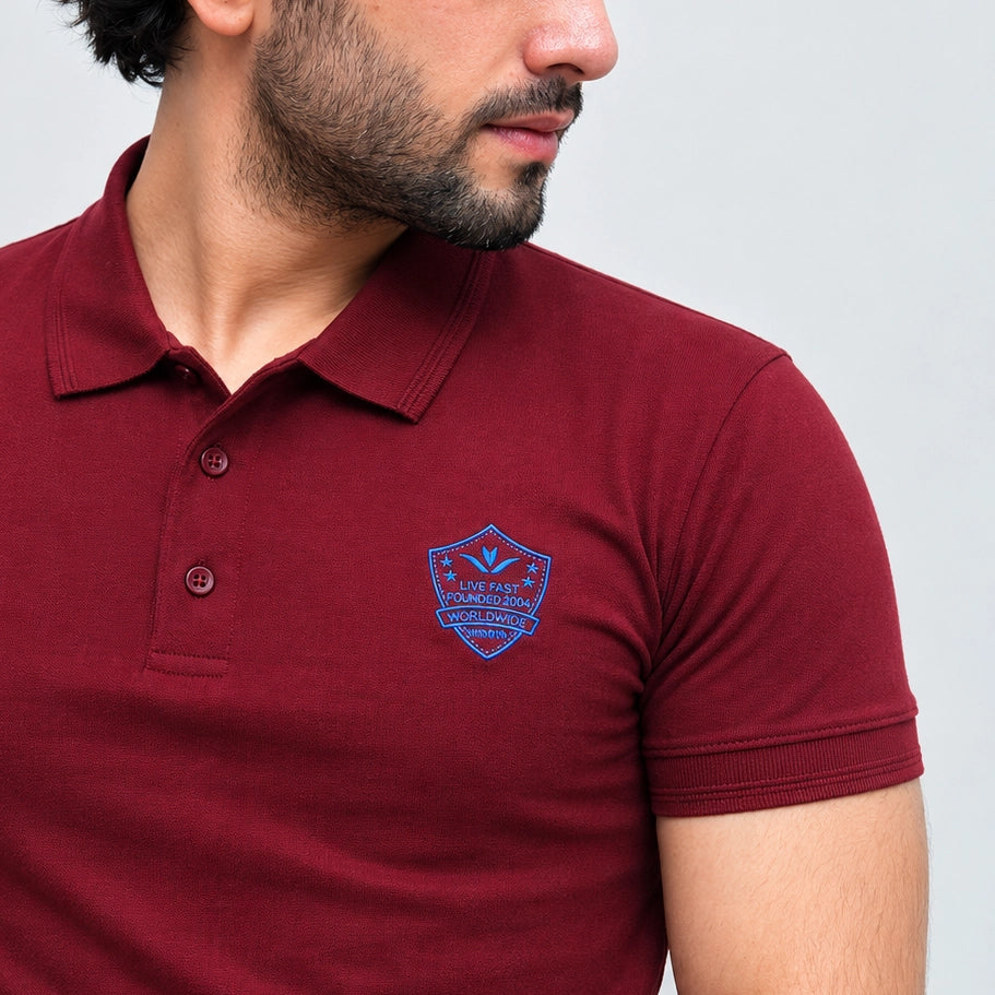 Maroon polo shirt chest embroidery detail close up
