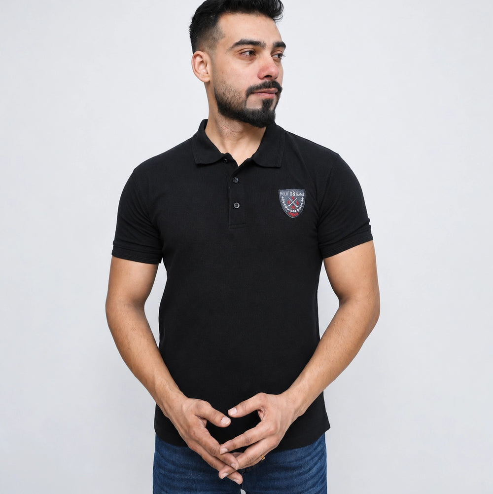 Close-up of embroidered chest logo on black men's polo shirt 2