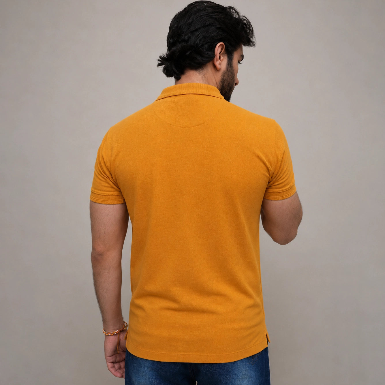 Mustard polo shirt back view showing regular fit and fabric texture