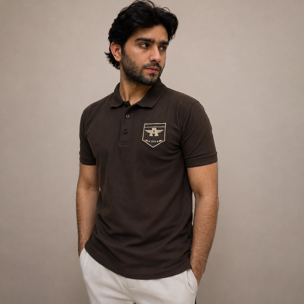 Brown embroidered polo shirt close-up showing chest embroidery detail and ribbed collar