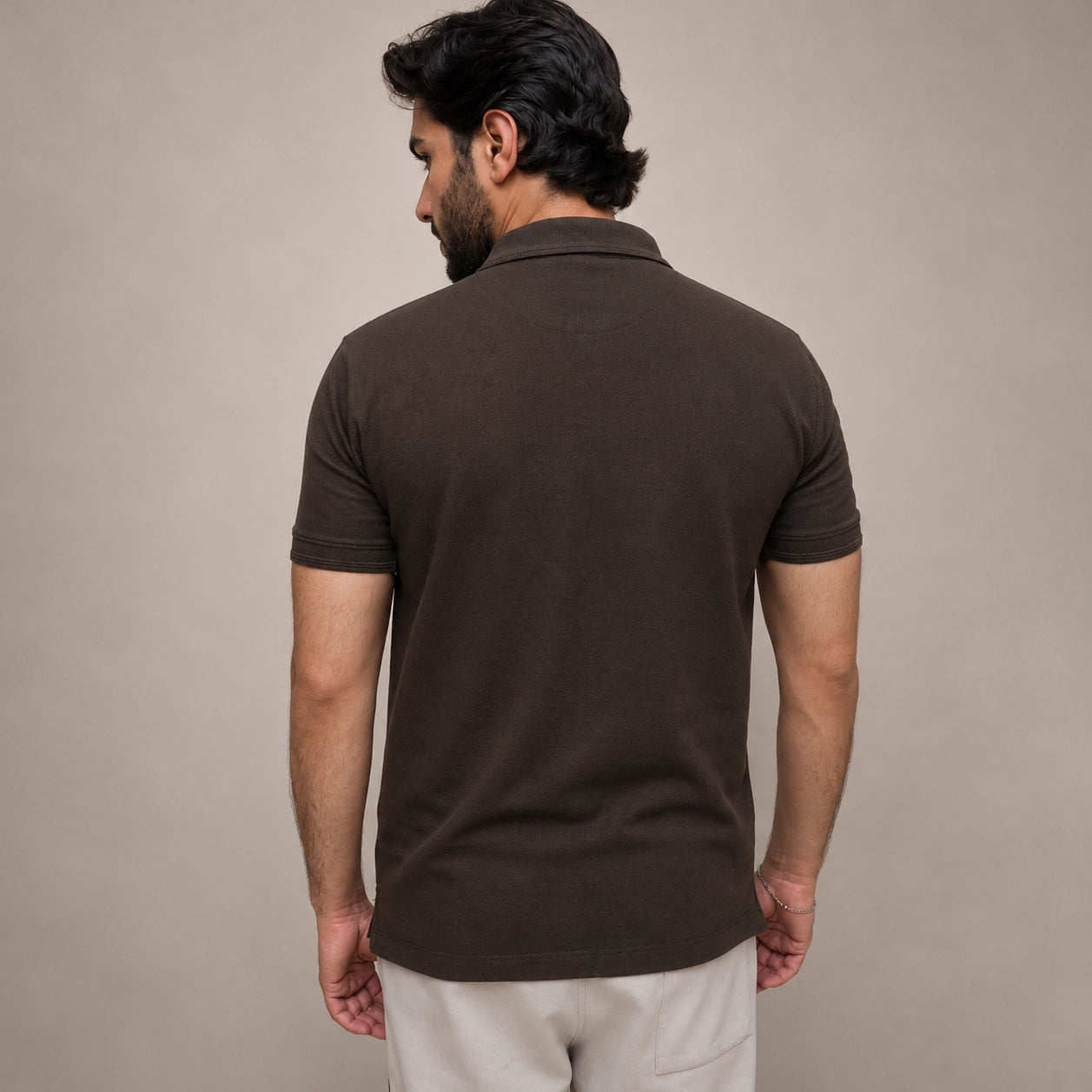 Brown polo shirt back view showing regular fit and ribbed cuff stitching
