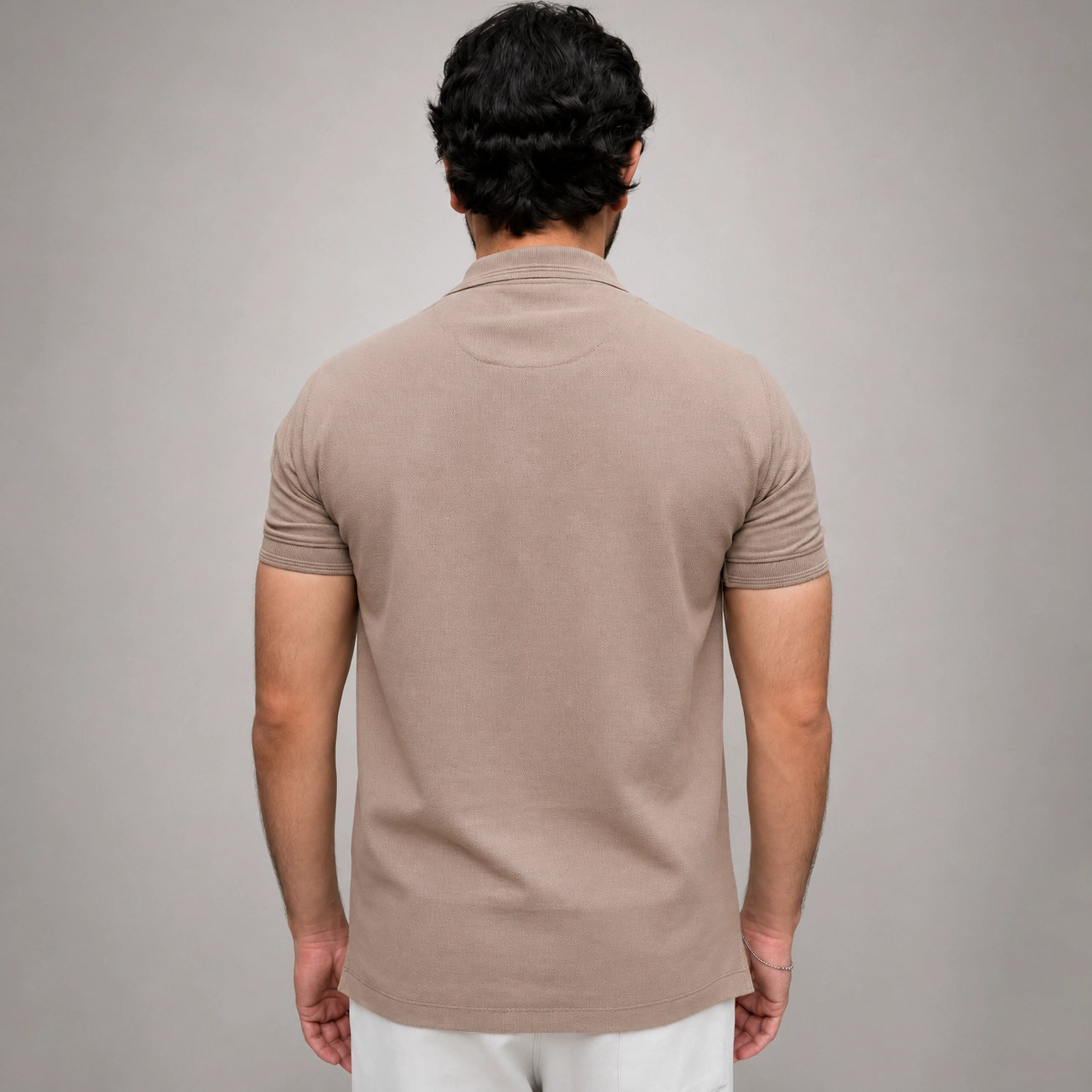 Men's beige polo shirt back view showing regular fit silhouette