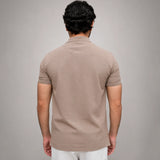 Men's beige polo shirt back view showing regular fit silhouette
