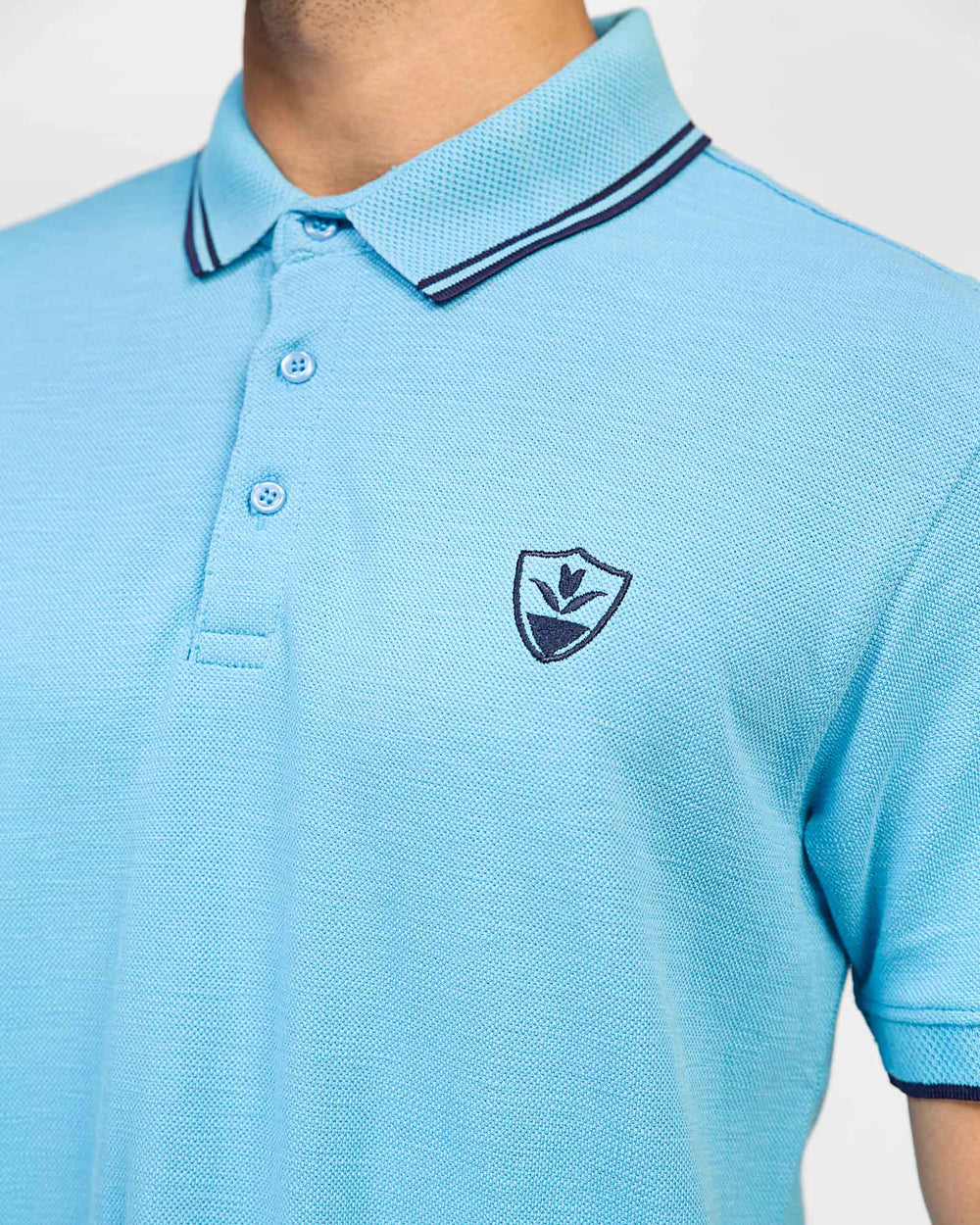 ADAM Men's Sky Blue Polo – Tipping Collar Detail and Chest Logo Close-Up
