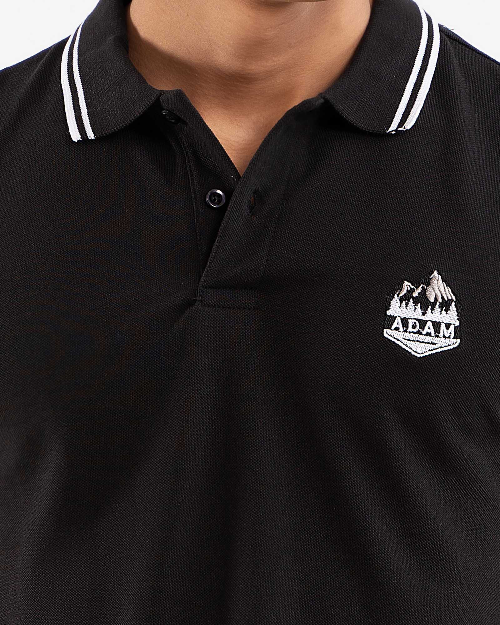 Black polo shirt, white tipping collar, side view