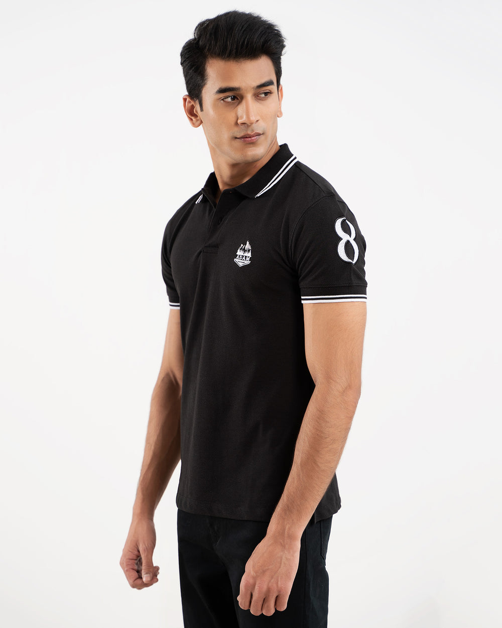 Black polo shirt, white tipping collar and cuffs, embroidered crest logo, "8" on sleeve, front