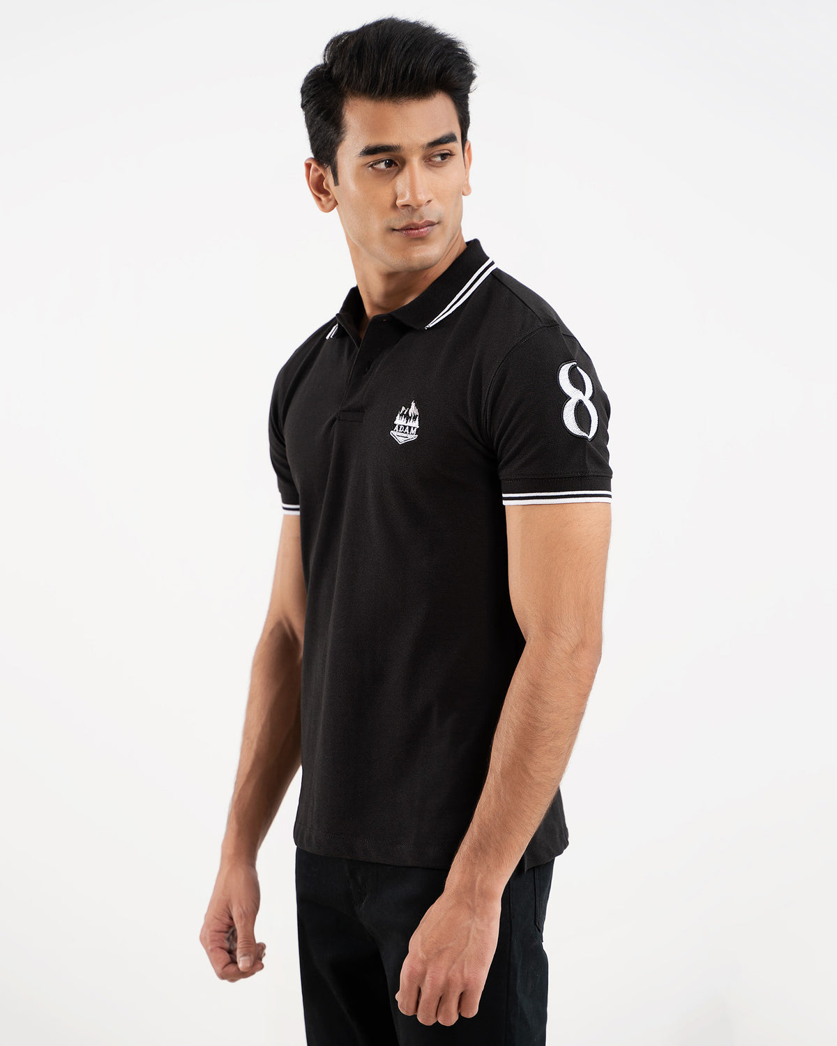 Black polo shirt, white tipping collar and cuffs, embroidered crest logo, "8" on sleeve, front