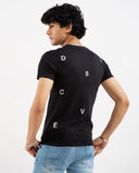 Man in black t-shirt with small letter prints scattered on back, back view