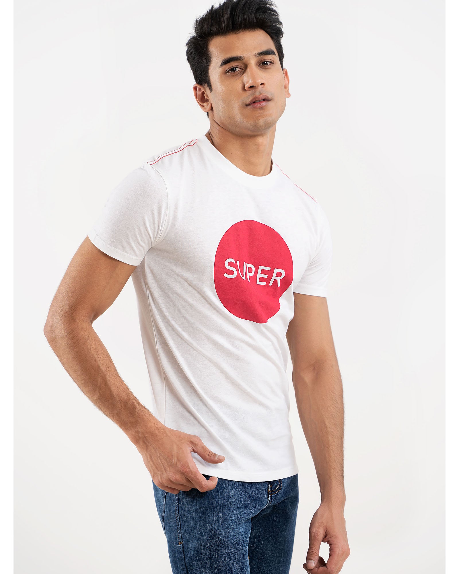 Man in white SUPER logo t-shirt, side view hand in pocket